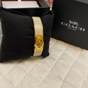 Coach Bracelet beige color and gold details.